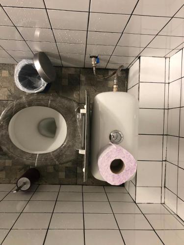 a bathroom with a toilet with a pink seat at Single Bed Center in Plovdiv
