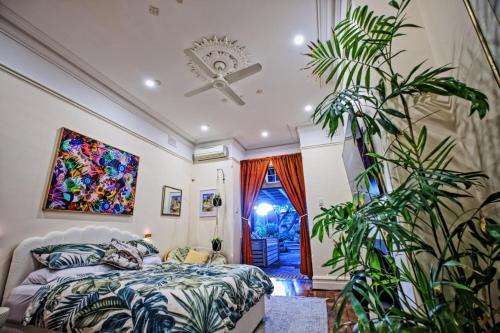 a bedroom with a bed and a large plant at Private sanctuary between river and sea in Perth