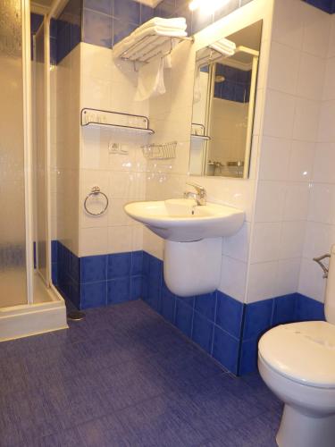 a bathroom with a sink and a toilet at Pensión Romero in Oviedo