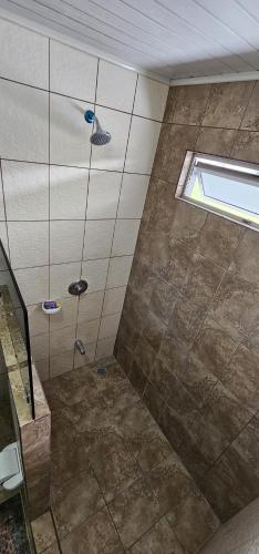a bathroom with a shower with a window at Costa Rica explorer in Grecia