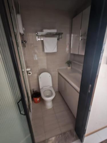 a small bathroom with a toilet and a sink at 城绩公寓 in Phnom Penh