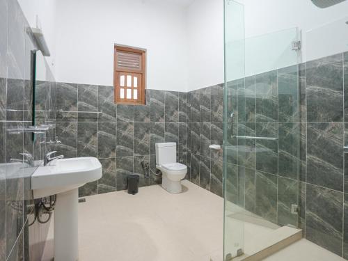 a bathroom with a toilet and a sink and a shower at Kandy 888 Villa in Kandy