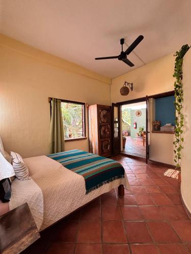 a bedroom with a bed and a ceiling fan at Hotel Artesanal Palomera in San Francisco
