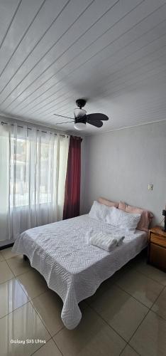 a bedroom with a bed with a ceiling fan at Costa Rica explorer in Grecia