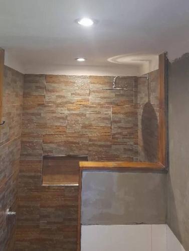 a room with a wall with a brick wall at Vertiente escondida in Villa Yacanto