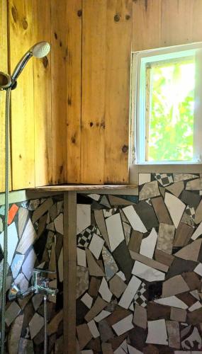 a bathroom with a shower and a window at Hostel La Ballena Backpacker in Las Galeras