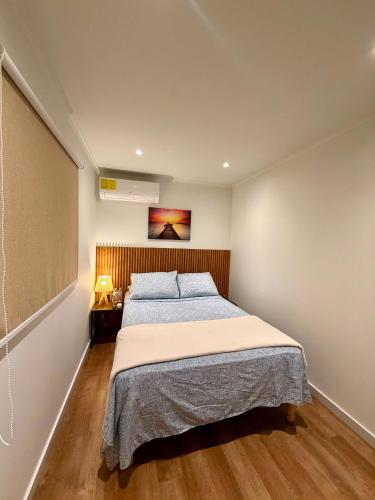 a bedroom with a bed and a painting on the wall at The Almas Container in Willemstad