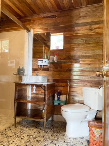 a bathroom with a toilet and a sink at COZY HOME PHU QUOC in Phú Quốc