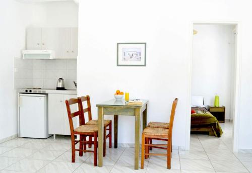 a small kitchen with a table and chairs at Paradise Apartments Studios in Mylopotas