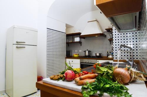 a kitchen with a bunch of vegetables on a counter at Casa Hellen Positano center in Positano