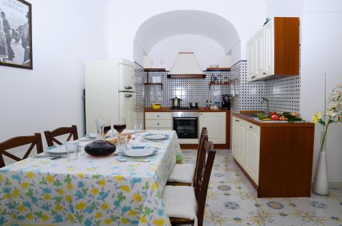 a kitchen with a table with a table cloth on it at Casa Hellen Positano center in Positano