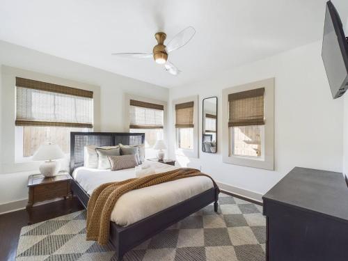 a bedroom with a large bed and windows at Buchanan Bungalow - Eclectic Mid-Mod Design DT in Lafayette