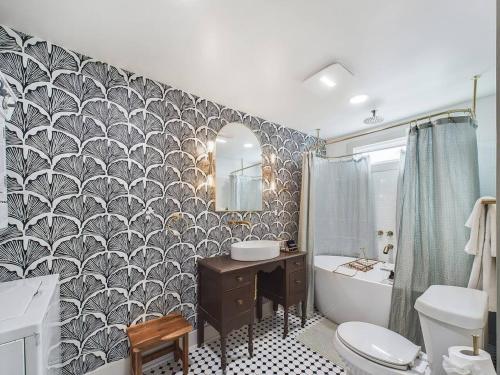 a bathroom with a toilet and a sink and a tub at Buchanan Bungalow - Eclectic Mid-Mod Design DT in Lafayette