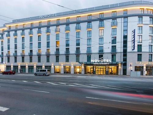 a building with a car parked in front of it at Novotel Nürnberg Centre Ville in Nuremberg
