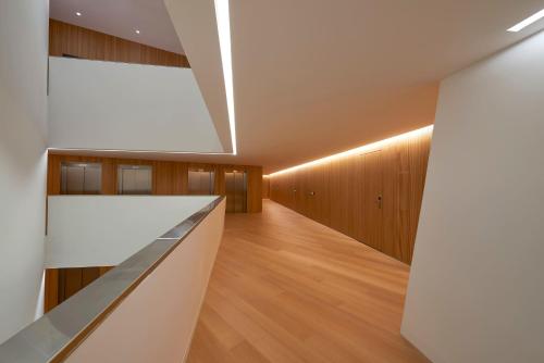 a hallway with wooden cabinets and a white wall at Meliá Palma Bay in Palma de Mallorca