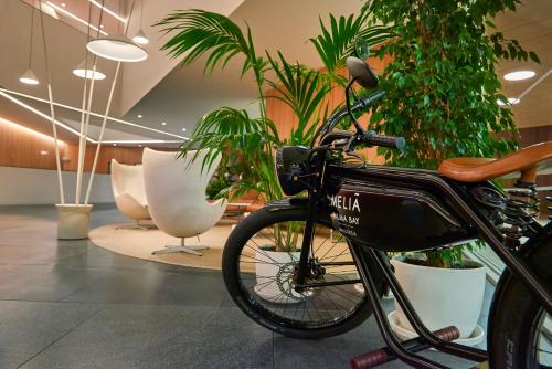 a bike parked in a room with potted plants at Meliá Palma Bay in Palma de Mallorca