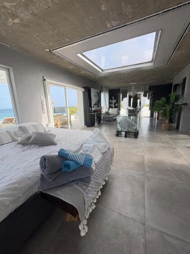a bedroom with a large bed with a large window at FIG PARADIS the villa in Philipsburg