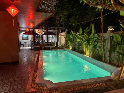 a swimming pool in the middle of a building at KunKin Boutique Garden Hue in Thôn Dương Xuân Hạ