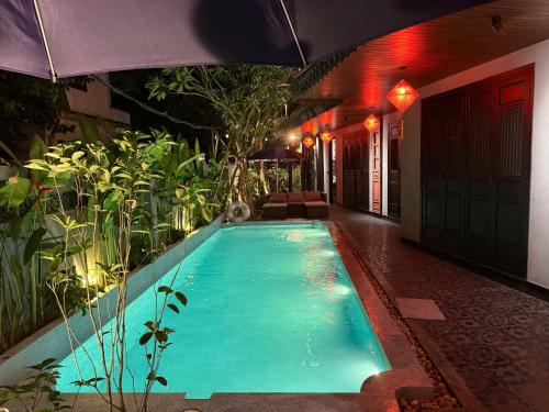 a swimming pool in the middle of a house at KunKin Boutique Garden Hue in Thôn Dương Xuân Hạ