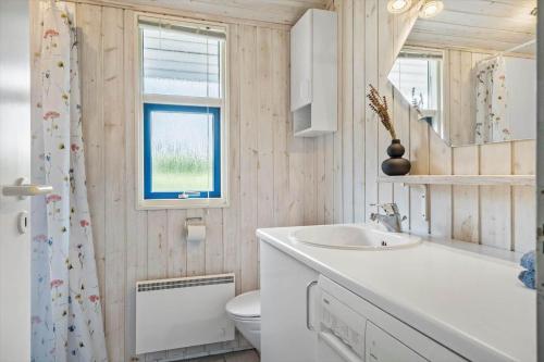 a bathroom with a sink and a toilet and a window at G112-Lemvig-Anemonevej-12 in Lemvig