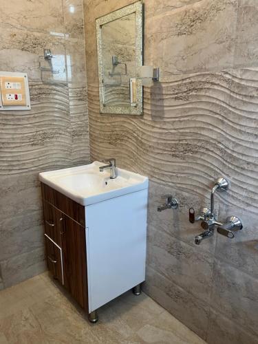 a bathroom with a sink and a mirror at p&q's guest house in Srinagar