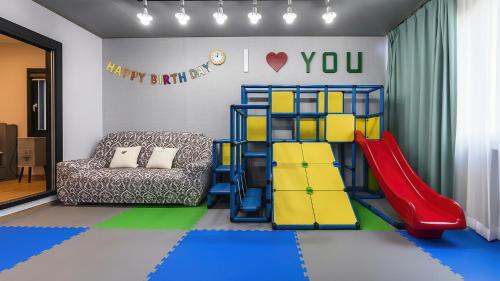 a childs play room with a slide and a playground at Goseong Pinetree Pension in Goseong