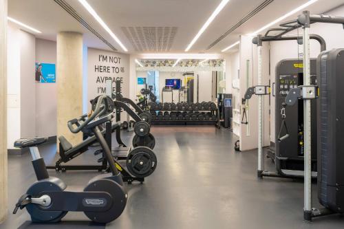 a gym with treadmills and machines in a room at INNSiDE by Meliá Manchester in Manchester