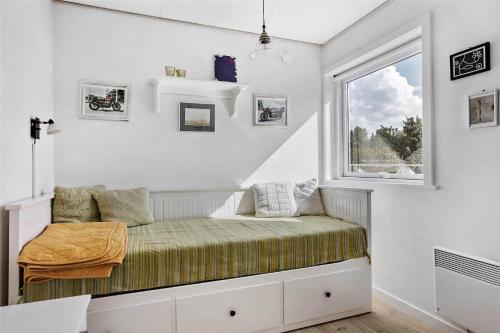 a bed in a room with a window at 13383-Asnaes-Glentevej-15 in Asnæs