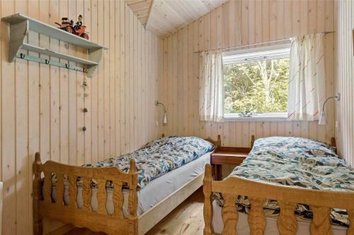 a bedroom with two beds and a window at 10039-Nykobing-Sj-Rishoj-Sidevej-9 in Nakke