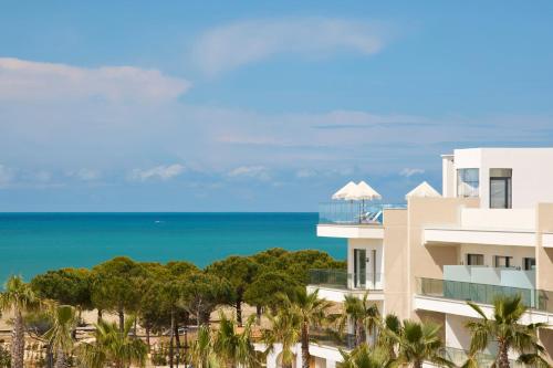 a view of a building with the ocean in the background at Meliá Durres Albania in Draç
