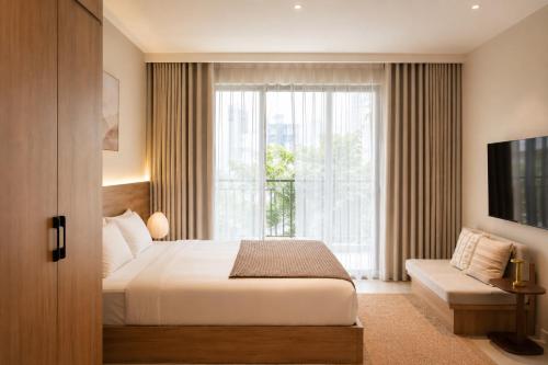 a bedroom with a bed and a large window at Harbor Point Quoc Huong, Thao Dien in Ho Chi Minh City