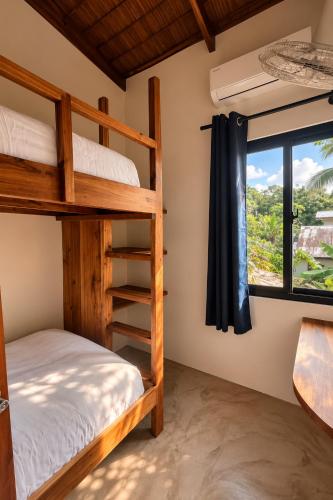 a bedroom with two bunk beds and a window at DILAW Villa avec piscine privée in El Nido