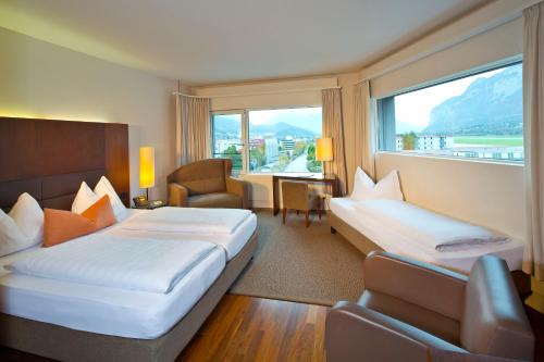 a hotel room with two beds and a window at Hotel Penz West in Innsbruck