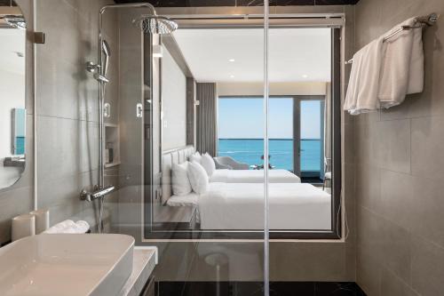 a bathroom with a view of a bedroom at Sunset Beach Resort & Spa- Beachfront Pirate Fire Show in Phú Quốc