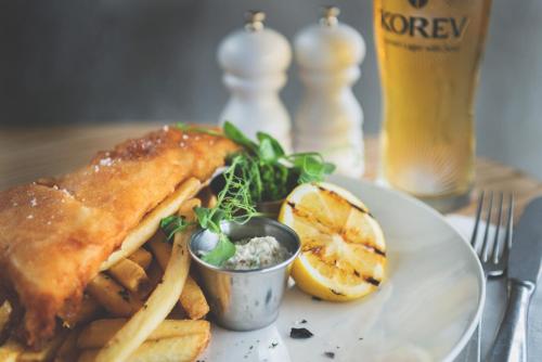 a plate of food with a fish and french fries at Havener's in Fowey
