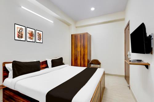 a bedroom with a large bed and a tv at Collection O Sadar Bazar Gurgaon in Gurgaon