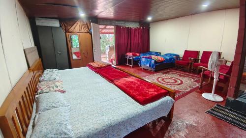a bedroom with a large bed in a room at Estateview Villa Homestay in Sakleshpur