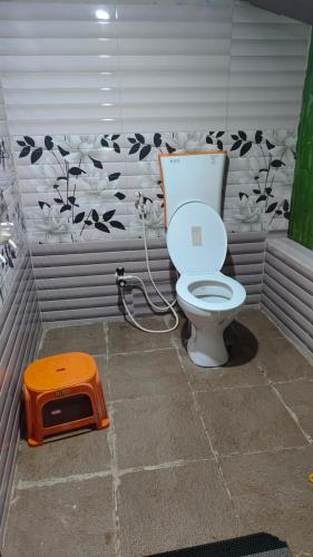 a bathroom with a toilet in a room at Estateview Villa Homestay in Sakleshpur