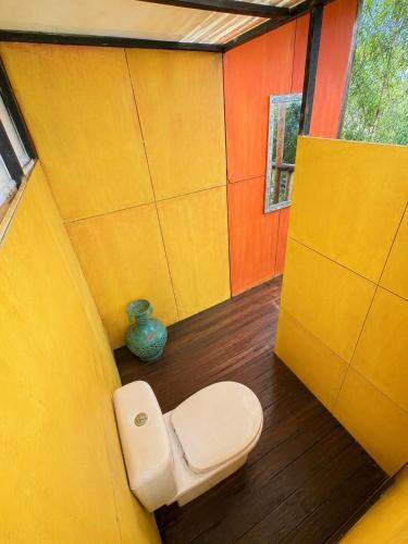 a bathroom with a toilet in the corner of a room at The Secret Sanctuary in Kuching