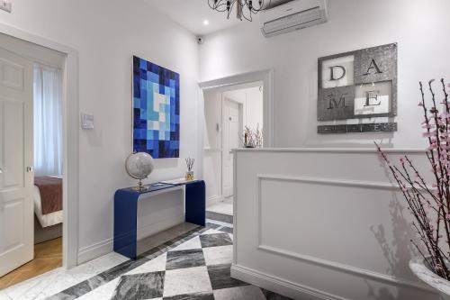 a living room with white walls and a checkered floor at DA ME Suites in Rome