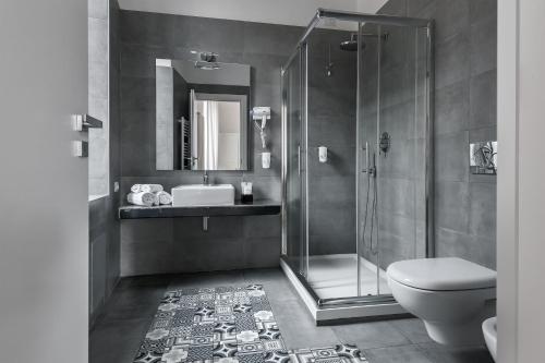 a bathroom with a shower and a toilet and a sink at DA ME Suites in Rome