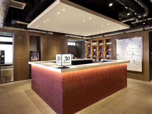 a bar with a price sign on top of it at 30 PIECES Namba in Osaka