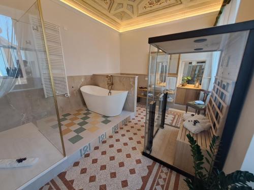 a large bathroom with a tub and a shower at Garden Palace Hotel in Castiglione del Lago