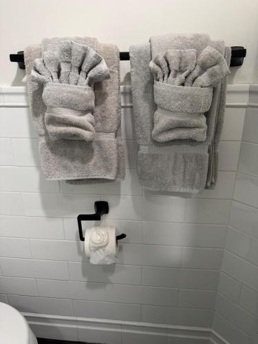 a bunch of towels hanging on a wall in a bathroom at Studio - NYC, Greenwich, Capitol, Parking in Port Chester