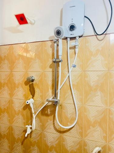 a shower in a bathroom with a camera on the wall at Villa Dinusara in Weligama