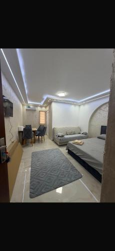 a room with two beds and a table and a bed sqor at melvina LUX in Pančevo