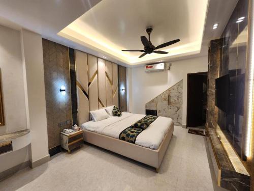a bedroom with a bed and a ceiling fan at Beach Anaya Food Junction & Resort in Cox's Bazar