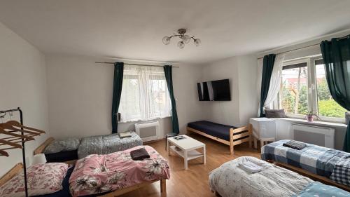 a living room with two beds and a couch at Pokoje w Gołdapi in Gołdap