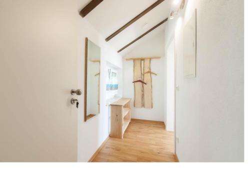 a hallway with white walls and a white door at Ferienwohnung Rohrhofer in Tiefenbach