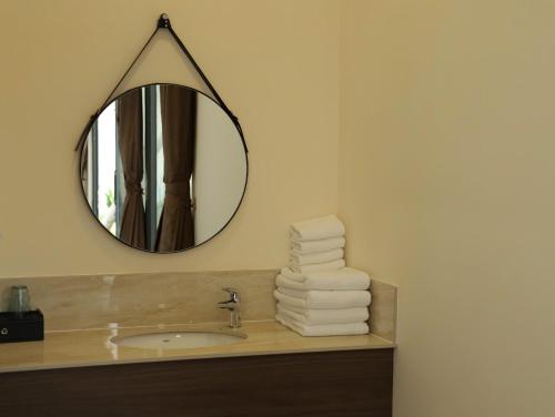 a bathroom with a sink and a mirror at 86 Villa in Mui Ne